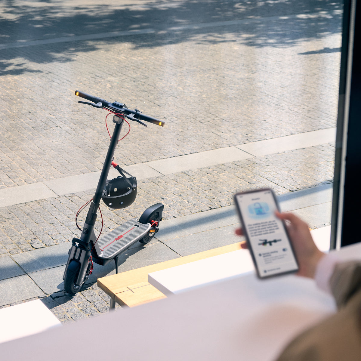 Segway F3 Pro parked outside while a rider checks their phone